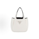 PRADA, a white women\'s handbag with a metal engraved logo and magnetic clasp, featuring a shoulder strap and a vegetable basket